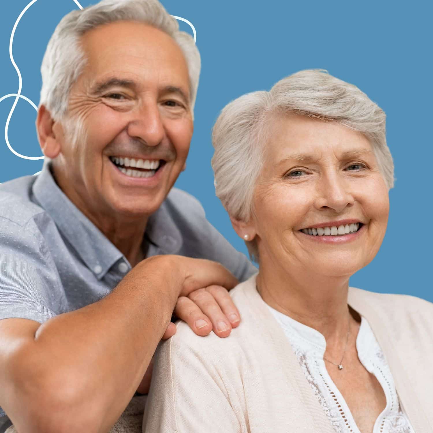 Older couple smiling after dental implants