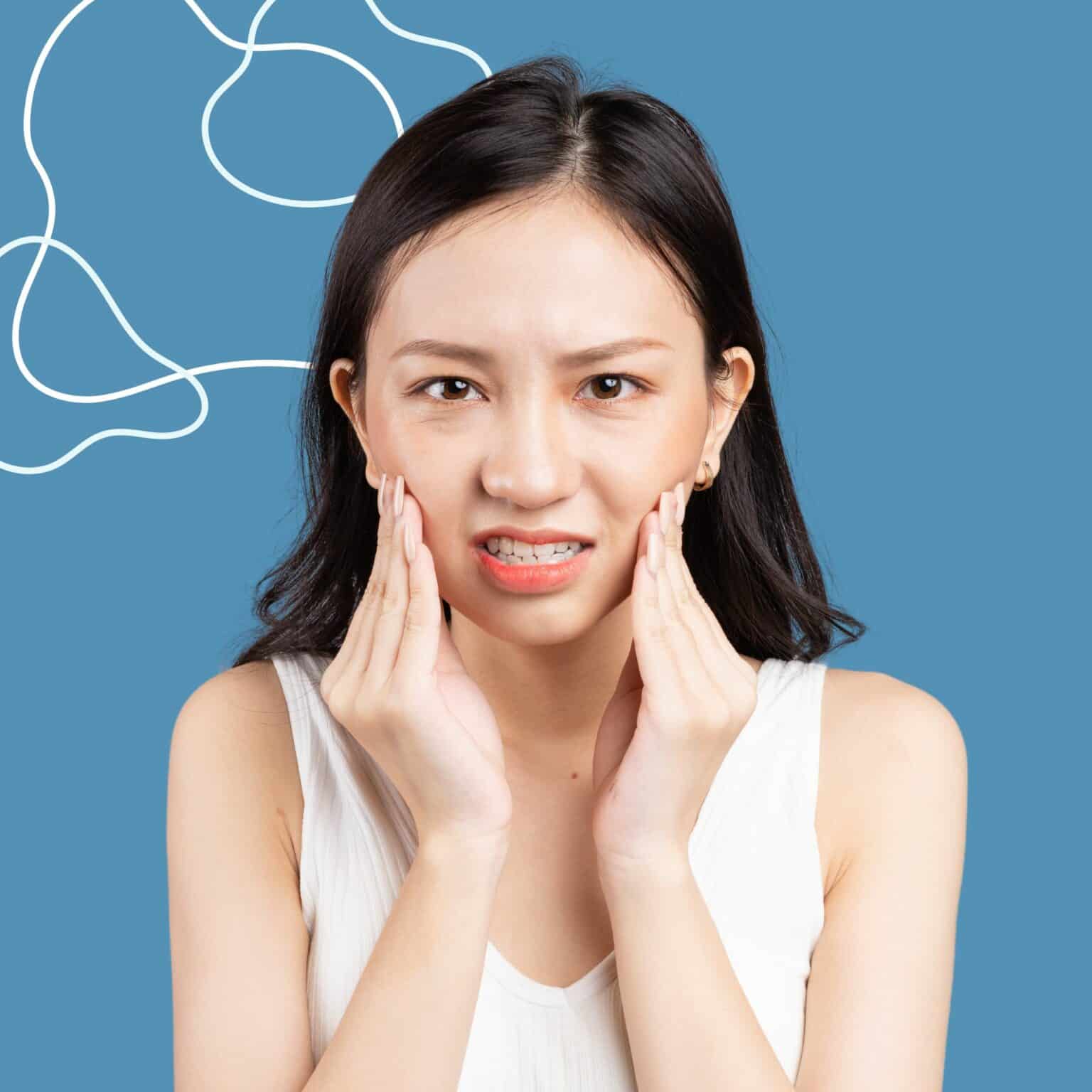 Person holding jaw in pain
