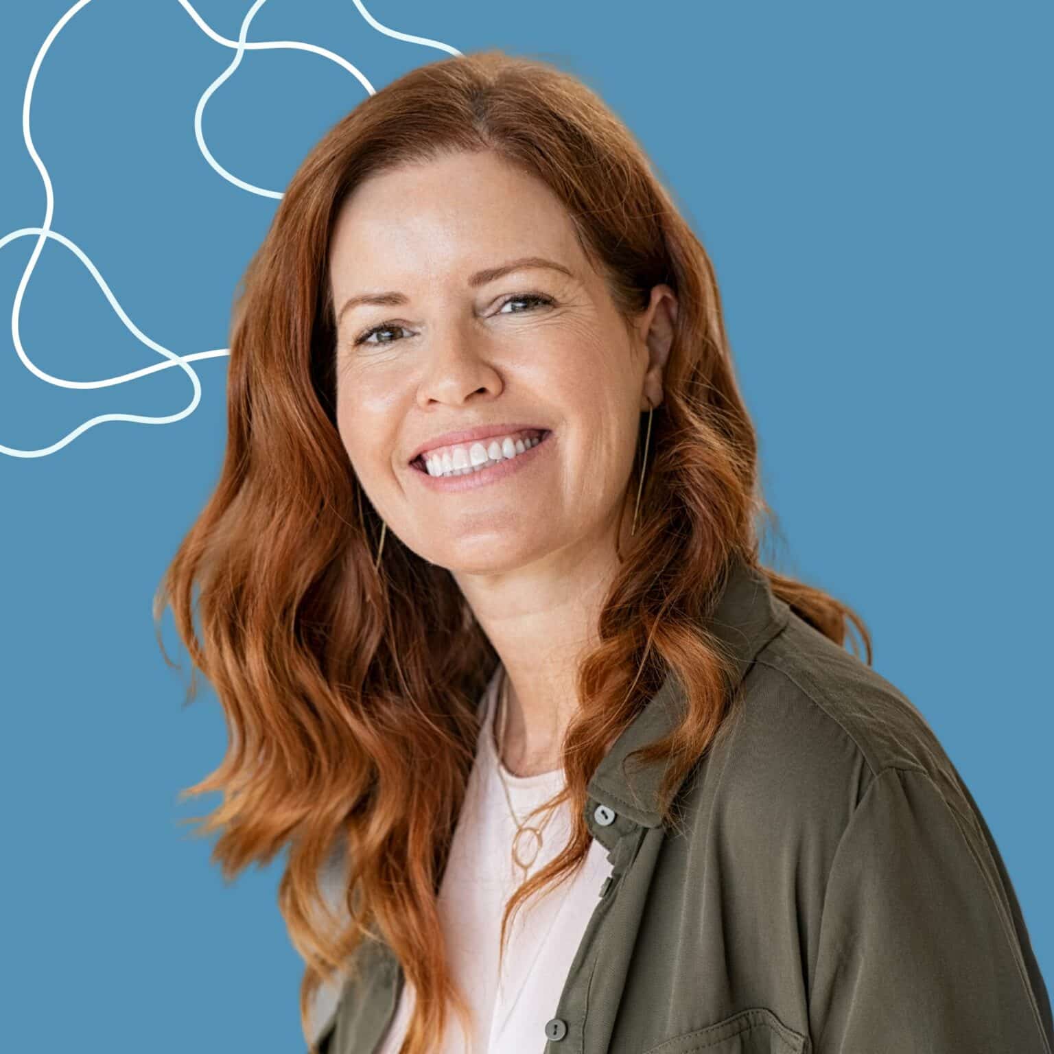 Red haired woman smiling with white teeth