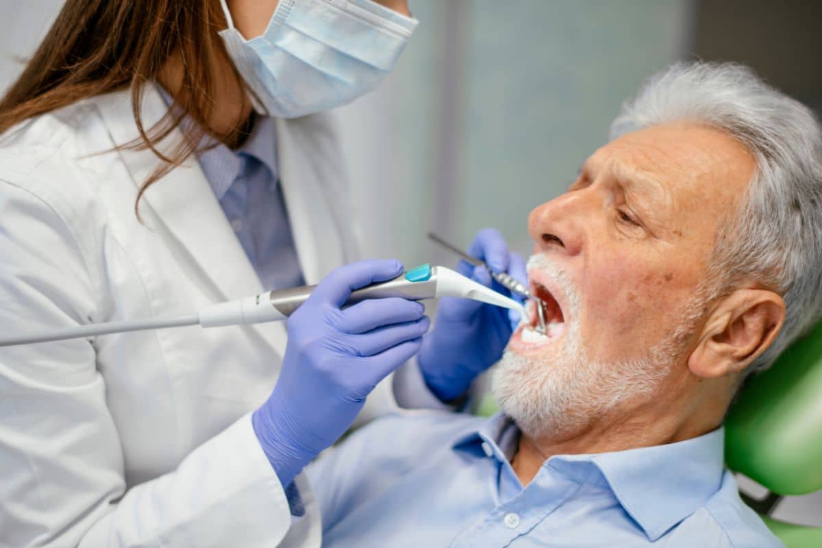 Dentist performing a bone graft on patient