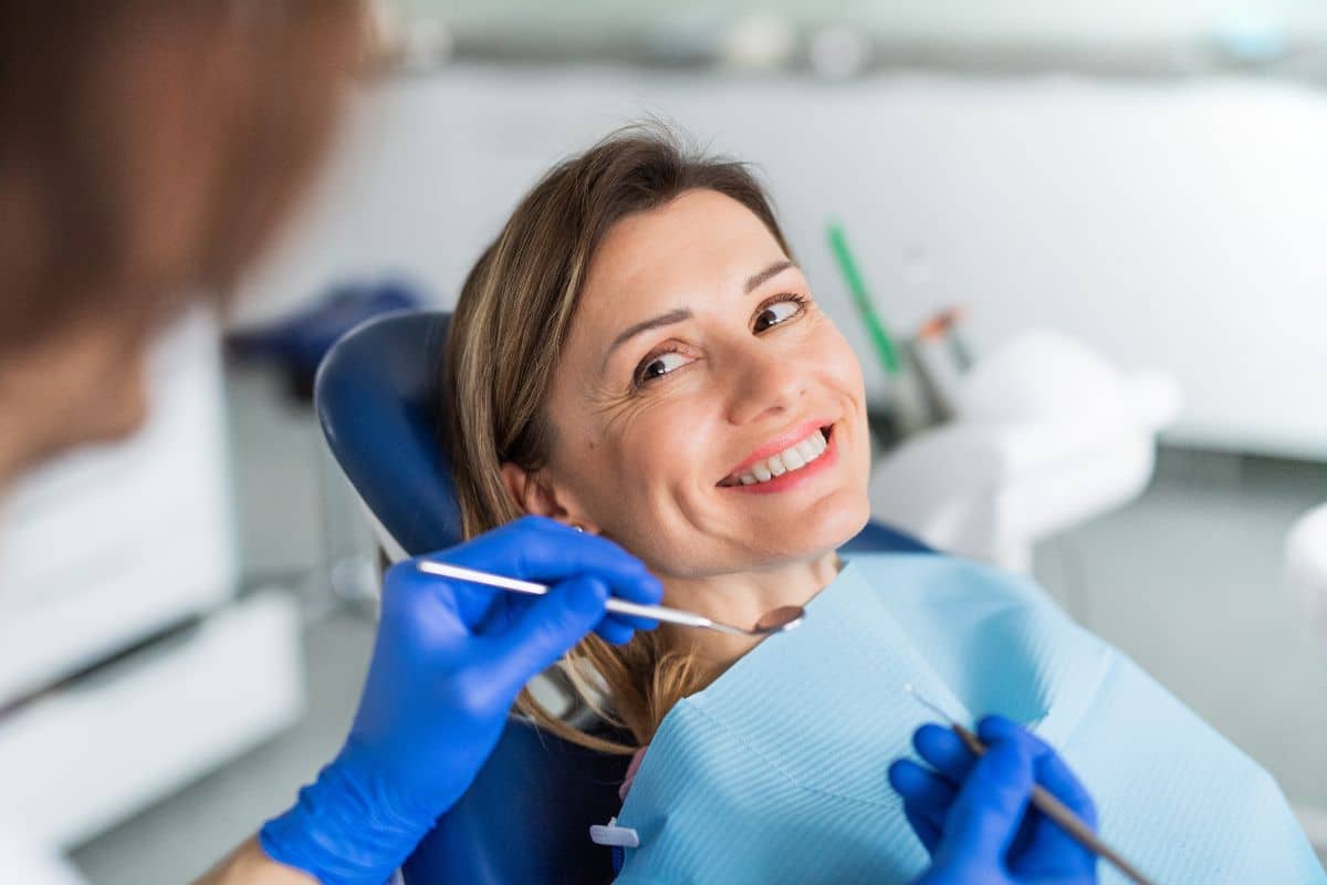 Woman in chair smiling at dentist