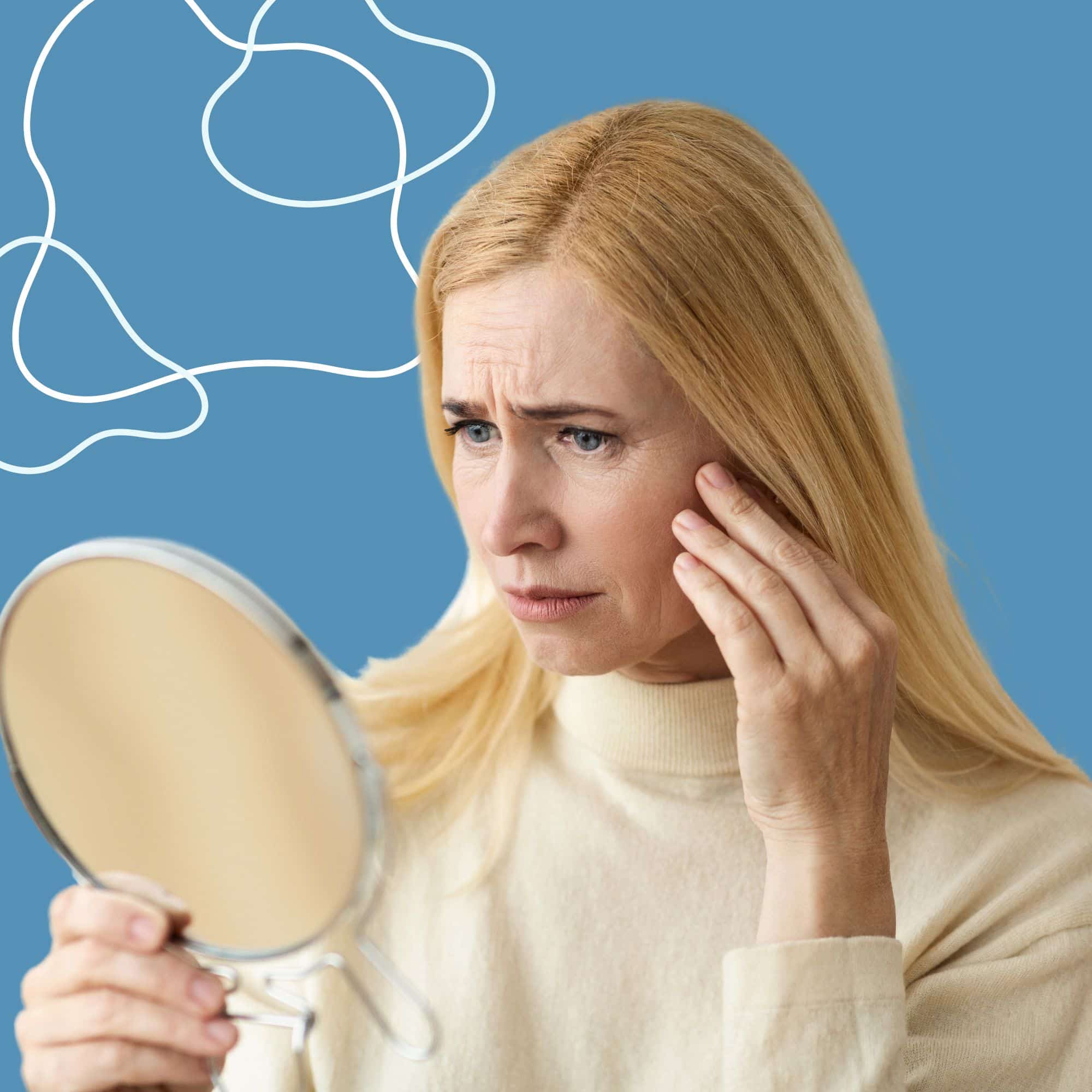 Woman looking in the mirror after facial trauma